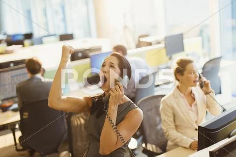 Exuberant woman on telephone celebrating good news in office Stock Photos