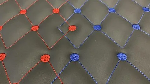 Eye catching geometric patterned leather with red and blue stitching Stock Photos