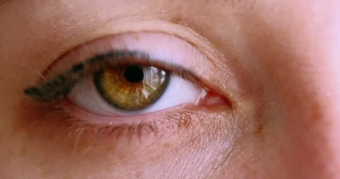Eye close-up. pupil is expansion. static video. woman blinks, looking at camera Stock Footage 126654501