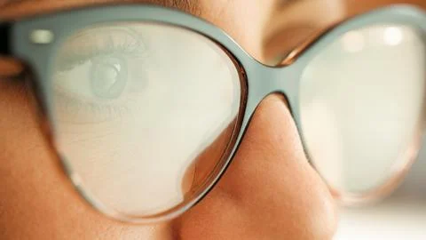 The eye of a computer hacker as he monitors a computer screen. Stock Photos