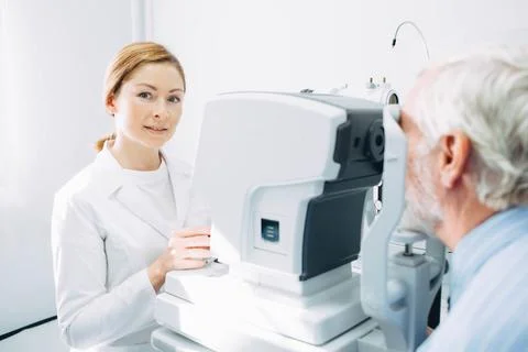 Eye doctor while working while working at her workplace in clinic Fotos de archivo