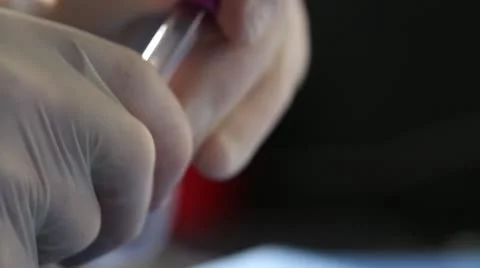 Eye dropper transfers liquid between cylinders Stock Footage 20446624