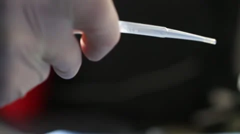 Eye Dropper transfers liquid from one cylinder to another Stock Footage 20447082