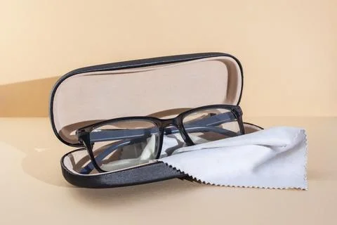 Eye glasses with rectangular black frame in a opened hard case box with a c.. Фото