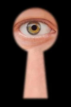 Eye in keyhole Stock Photos