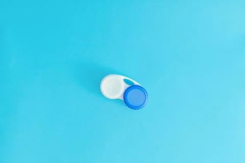 Eye lens case on blue background Stock Photos