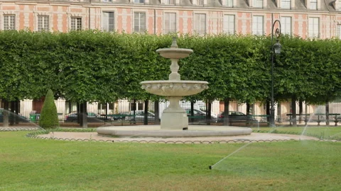 Eye-level centered view of a historic tiered stone fountain in Place des Vosges, Stock Footage 338006270