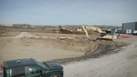 Eye-Level Drone Travel Through Active Construction Site With Heavy Machinery Stock Footage 145377937