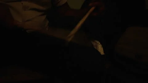 Eye-level, male drummer practicing with drum sticks on his knees in backstage Stock Footage 133491524