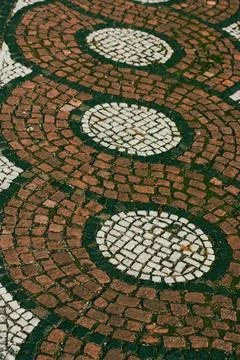This eye-level shot captures a patterned cobblestone pavement, featuring Stock Photos