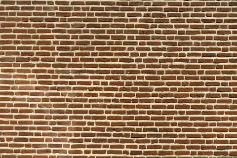 Eye-level shot of a dark red brick wall background Stock Photos