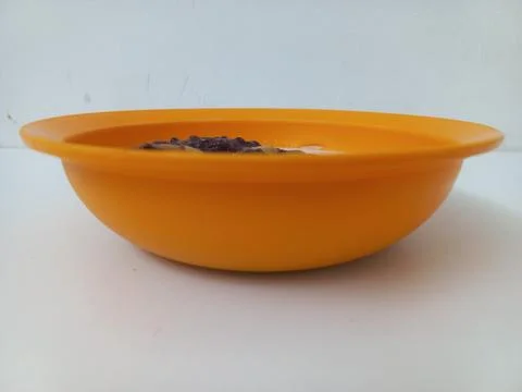 Eye Level Side View of Orange Bowl Filled with Sweet Porridge Stock Photos