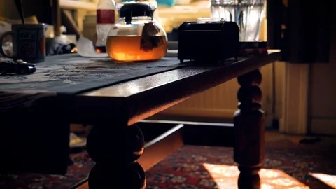 Eye level. Slowmo, A remote controlled car uses a table runner on a wooden Stock Footage 116400150