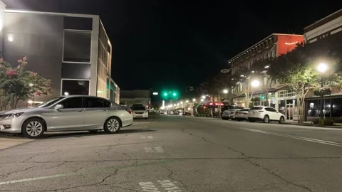 Eye level time lapse of city street and intersection at night Stock Footage 204077148