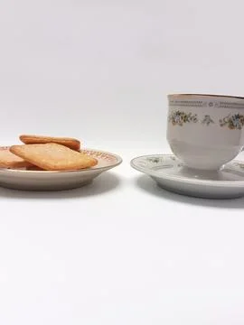 Eye Level View of Black Coffee Cup and Sugar Biscuits on Plate Stock Photos