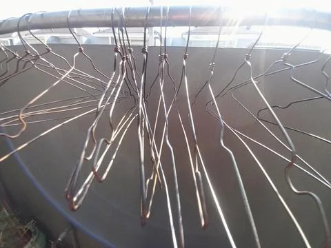 Eye-Level View of Empty Wire Clothes Hangers Hanging on Metal Laundry Rack Stock Photos