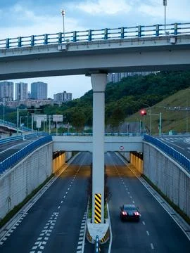 Eye level view of an internchange, it's tunnel illuminated with warm light. Stock Photos