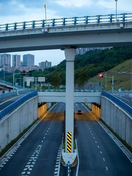 Eye level view of an internchange, it's tunnel illuminated with warm light. Stock Photos