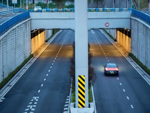 Eye level view of an internchange, it's tunnel illuminated with warm light. Stock Photos