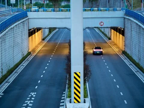 Eye level view of an internchange, it's tunnel illuminated with warm light. Stock Photos