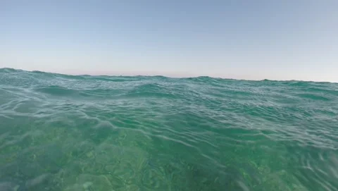Eye level view of turquoise ocean water waves Stock Footage 344751681