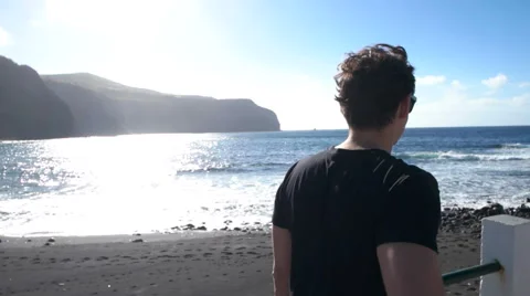 Eye leveled shot of man walking next to the beach Video stock 59337493