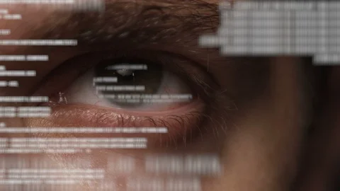 Eye looking at program code on transparent screen or holographic interface Stock Footage 93850174
