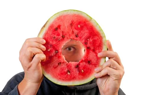 Eye looking through watermelon slice Foto stock