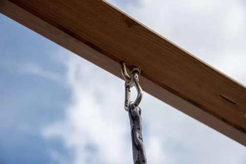 Eye-loop screw mount on bottom of wooden beam Stock Photos