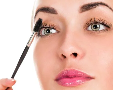 Eye makeup. Applying mascara on the lashes. Portrait of a woman close up Stock Photos