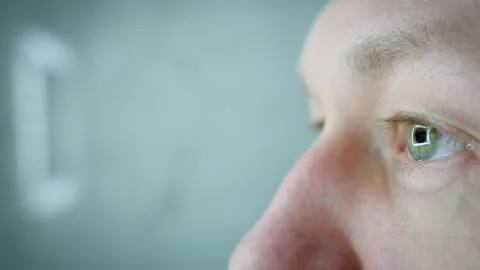 The eye of a man looking into the distance. Reflection of the lamp in the pupil Stock Footage 312763599