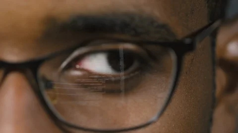 Eye of Man Reading Computer Codes Video stock 103526950