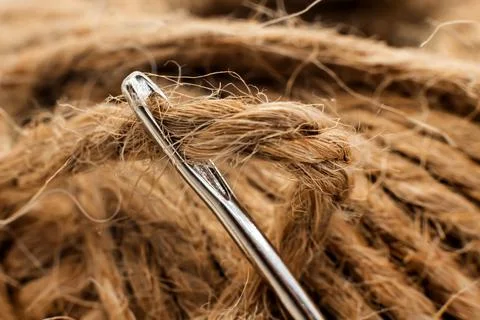 The eye of a needle for sewing with thread close-up. Needle with twine Stock Photos