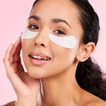 Eye patch, face mask and beauty of a woman with natural skin glow on a pink Stock Photos