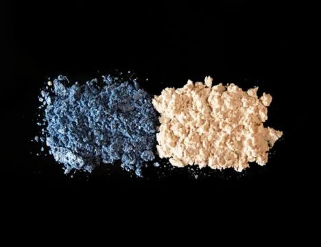 Eye shadow on black background. Blue and  ivory-coloured eye shadow Stock Photos