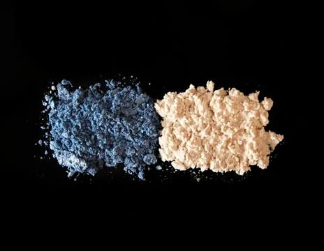 Eye shadow on black background. Blue and  ivory-coloured eye shadow Stock Photos