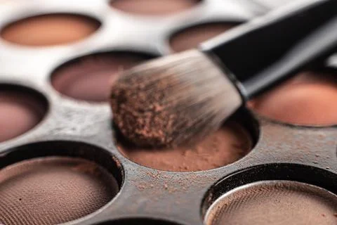 Eye shadow is close. A makeup brush with eye shadow on it scatters the grains Stock Photos