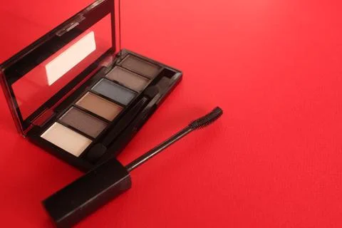 Eye Shadow ink on a red background with space for text. Background with decor Stock Photos