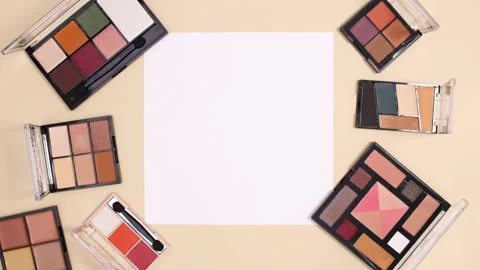 Eye shadow make up palettes and lipsticks appear around paper note. Stop motion Vídeo Stock 150666646