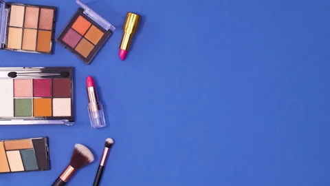 Eye shadow palettes and brushes and lipsticks appear on left side . Stop motion 스톡 동영상 153172522