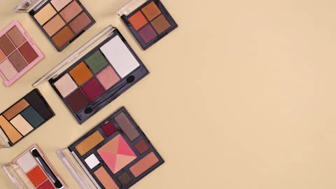 Eye shadow palettes appear on left side of beige background. Stop motion Stock Footage 150686530