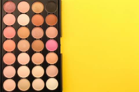 Eye shadow on yellow background. Stock Photos