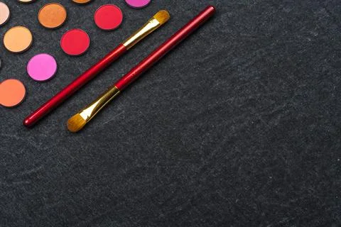 Eye shadows and two brusheson gray background Stock Photos