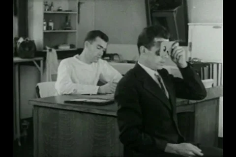 Eye specialists study and examine patient's eyesight - 1936 Stock Footage 93113308