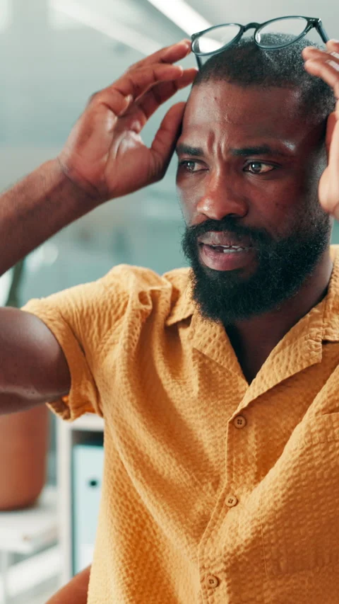Eye strain, glasses or black man in office with computer, tired or headache in Video stock 330536059