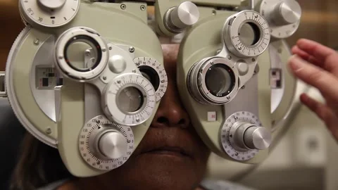Eye test being done by optometrist using Phoropter Stock Footage 143866277