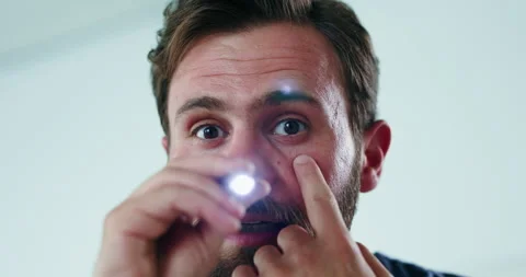 Eye test, light and doctor with face of man in hospital for pupil reflex, Stock Footage 326415105