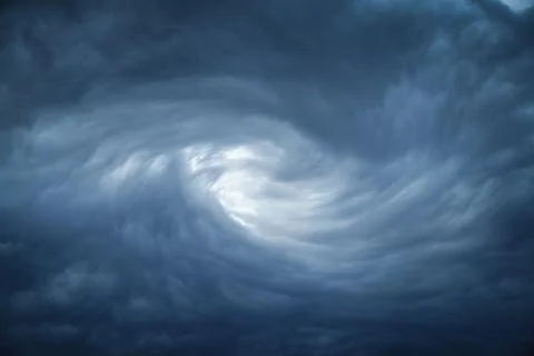 The eye of a tornado starts to create a vortex from grey couds Stock Photos