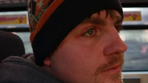 The eye twitches. The guy rides on the train and looks out the window. Addict 動画素材 124559078