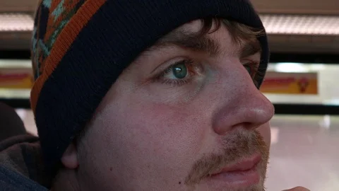 The eye twitches. The guy rides on the train and looks out the window. Addict 動画素材 124559081